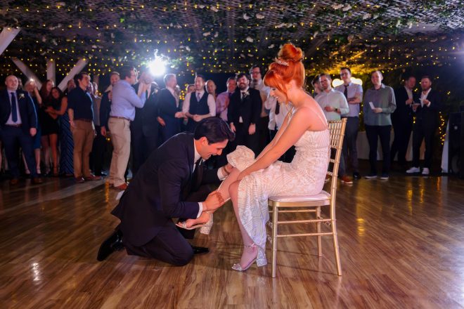 Garter removal moment at Las Vegas Rainbow Garden wedding reception dance floor
