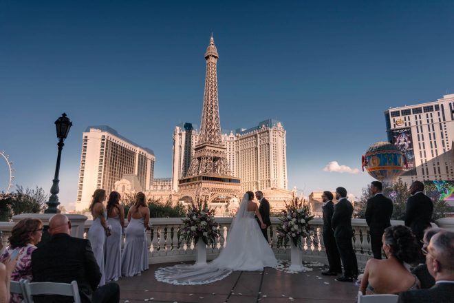 Las Vegas Strip wedding ceremony with Bellagio fountains and Eiffel Tower background