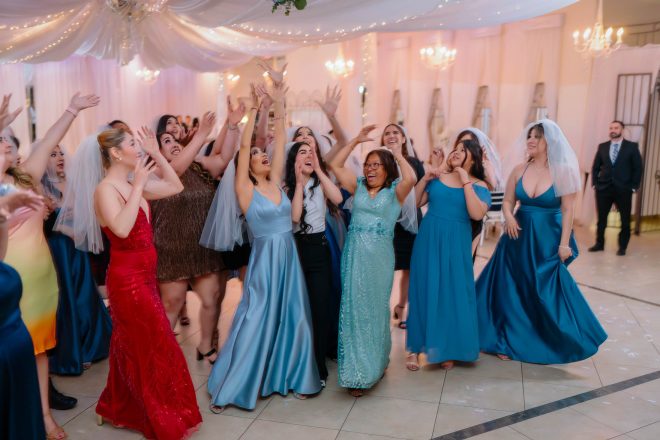 Bridesmaids catching bouquet during wedding reception celebration Las Vegas