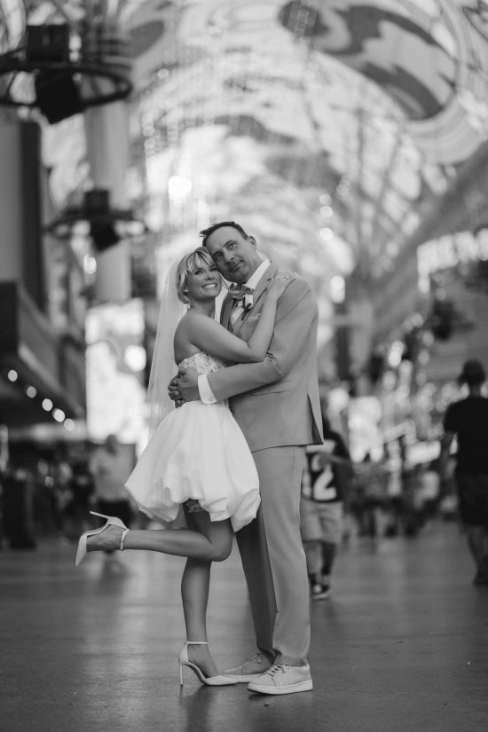 Romantic Las Vegas Downtown elopement portrait beneath the Fremont Street Experience canopy in timeless black and white.