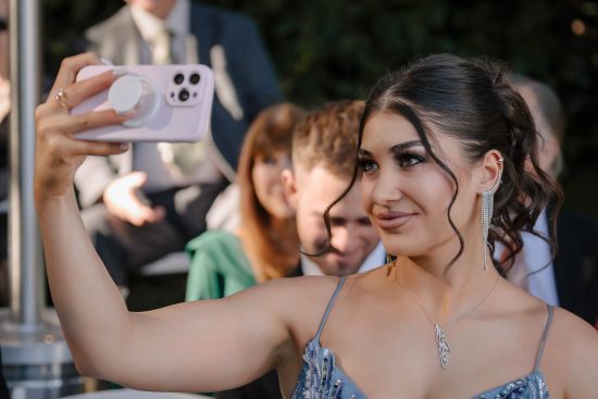 Maid of honor taking a selfie before an Armenian wedding ceremony at Lakeside Weddings & Events in Las Vegas