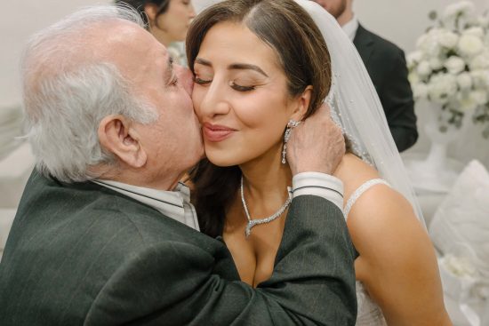 Bride sharing an emotional moment with her grandfather before an Armenian wedding in Las Vegas