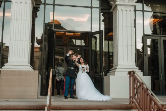 Bride and groom waving after their Caesars Palace wedding ceremony in Las Vegas.