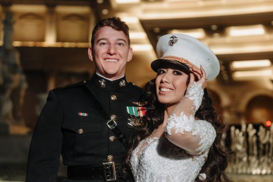 Bride wearing her U.S. Marine groom's dress cap during a luxury nighttime wedding portrait at Caesars Palace in Las Vegas.