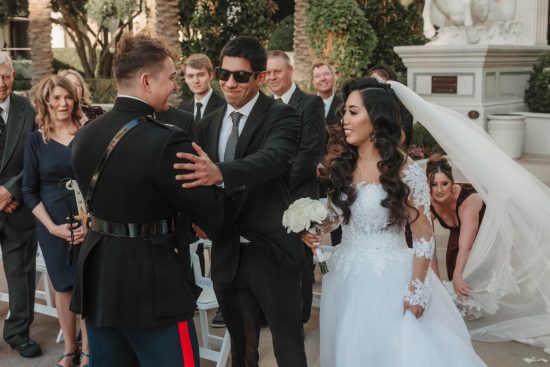 The groom greets a family member after the outdoor Caesars Palace wedding ceremony in Las Vegas.