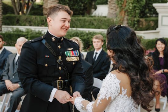 Bride and groom holding hands during their outdoor Caesars Palace wedding ceremony in Las Vegas.