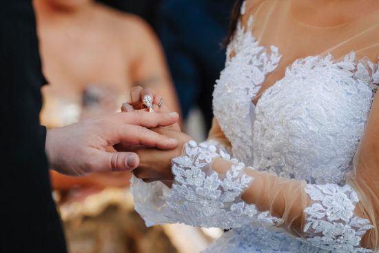 Close-up of the bride and groom exchanging wedding rings during a Caesars Palace wedding ceremony in Las Vegas.