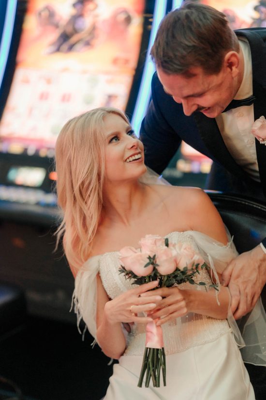 Bride and groom sharing a candid moment inside Paris Las Vegas after their intimate elopement.