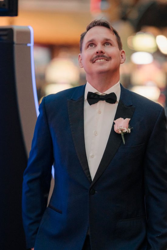 Groom smiling while waiting to see his bride during a Paris Las Vegas elopement.