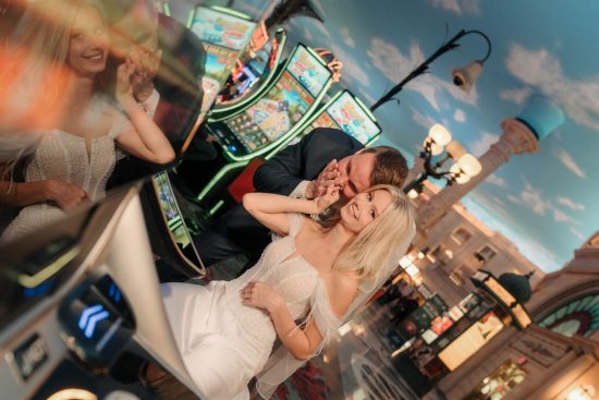 Bride and groom sharing a playful moment inside Paris Las Vegas during a romantic Las Vegas elopement photo session.