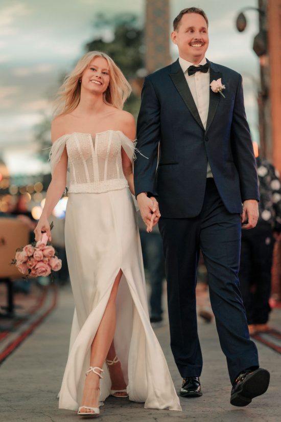 Bride and groom walking together at Paris Las Vegas after their luxury elopement ceremony
