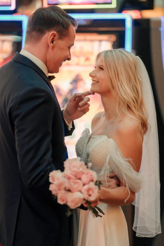 Bride and groom sharing a joyful moment inside Paris Las Vegas during their luxury elopement photo session