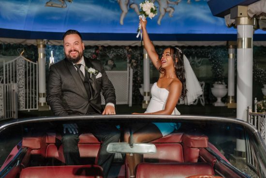 Bride and groom in the Pink Cadillac at Little White Chapel in Las Vegas after their wedding ceremony