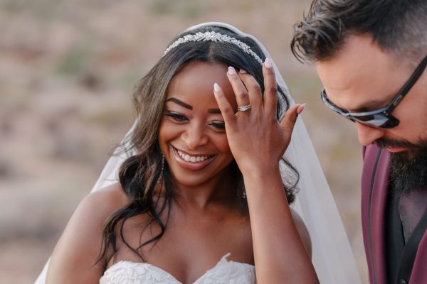 Smiling bride and groom during a sunrise wedding portrait at Calico Basin in Red Rock Canyon near Las Vegas