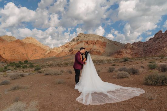 Bride and groom embracing during a sunrise wedding portrait at Calico Basin in Red Rock Canyon near Las Vegas