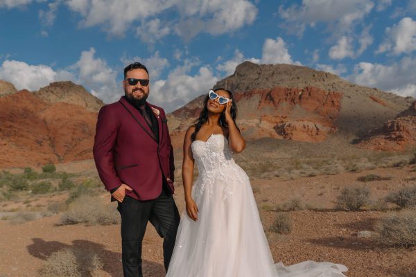 Bride and groom wearing sunglasses during a sunrise wedding portrait session at Calico Basin in Red Rock Canyon near Las Vegas